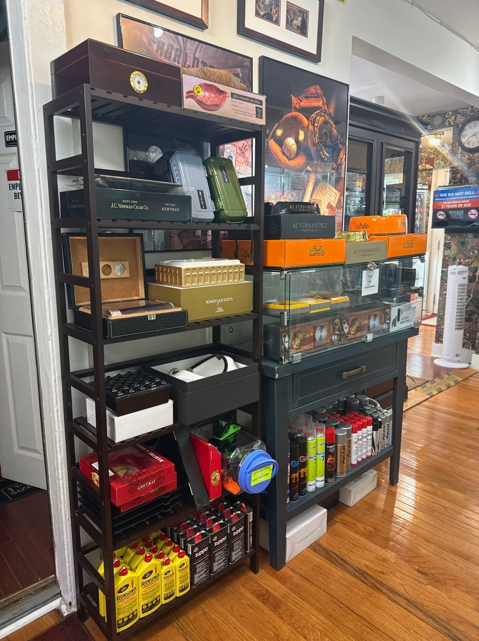 Shelf of cigar accessories, torch lighters, and cases at Reston Cigars & Vapes