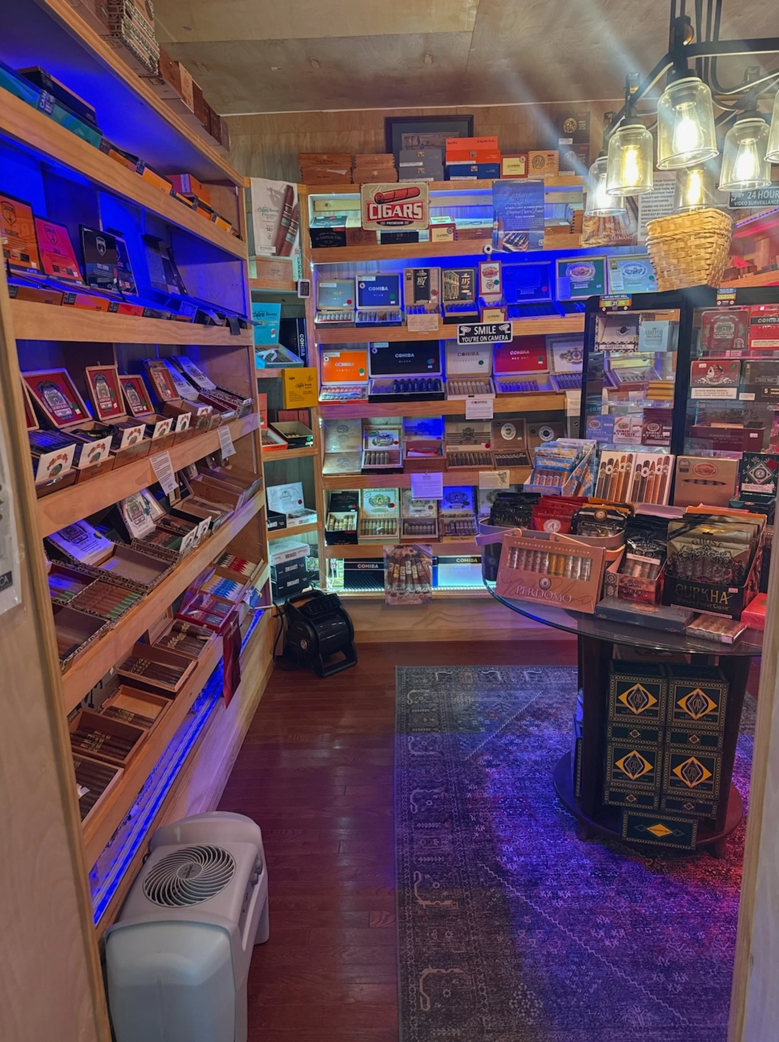 Cigar display shelves and tasting table inside Reston Cigars & Vapes
