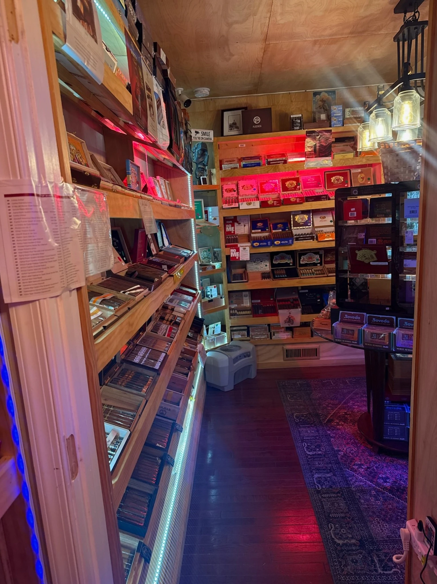 Narrow humidor storage aisle lined with cigar boxes at Reston Cigars & Vapes